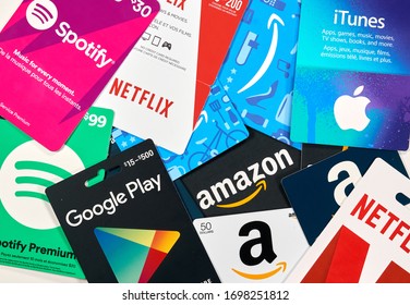 Montreal, Canada - April 6, 2020: Different gift cards of many brands such as Amazon, Netflix, Xbox, Google Play, Best Buy, Spotify. A gift card is a prepaid card that you use to pay for purchases