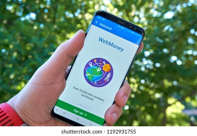 MONTREAL, CANADA - August 28, 2018: Webmoney android app on Samsung s8 screen in a hand.
