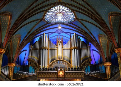 MONTREAL, CANADA - CIRCA OCTOBER 2016: Impressive lighting seen within a large Cathedral showing the detail of the roof, altar and large pipe organ section.