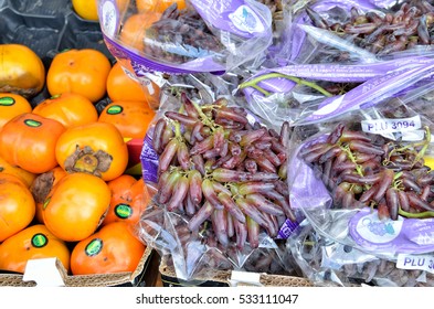 Montreal, Canada - July 26, 2014: Fruit Display Of Persimmons And Witch Finger Or Tear Drop Grapes At Jean-Talon Farmers Market