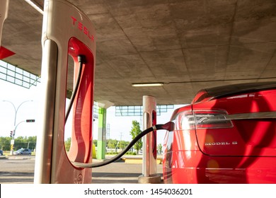 MONTREAL, CANADA - June 9, 2019: Tesla Model S plugged-in, supercharging at Tesla Supercharging Stall in Montreal, Quebec at Place Vertu Shopping Centre. 