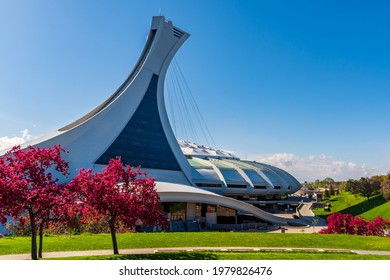 Montreal, Canada - May 2021 : Beautiful Spring View Of The Olympic Stadium Tower With Colorful Trees In Bloom