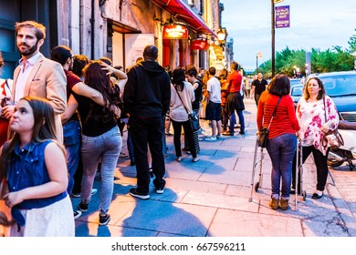 Montreal, Canada - May 27, 2017: Old Town Area With People Waiting In Line Queue Outside Restaurant During Evening Night In Quebec Region City