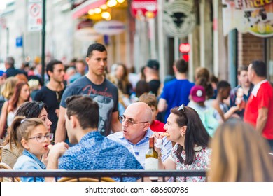 Montreal, Canada - May 27, 2017: Old Town Area With People Sitting Eating Food And Enjoying Atmosphere In Evening Outside Restaurant In Quebec Region City