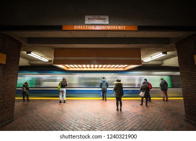 MONTREAL, CANADA - NOVEMBER 3, 2018: People Waiting For A Subway In Snowdon Station Platform, Orange Line, While A Metro Train Is Coming, With A Speed Blur

