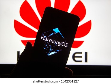 Montreal, Canada - October 25, 2019: HarmonyOS on a Samsung Galaxy S9 Plus' display over Huawei logo on a laptop.