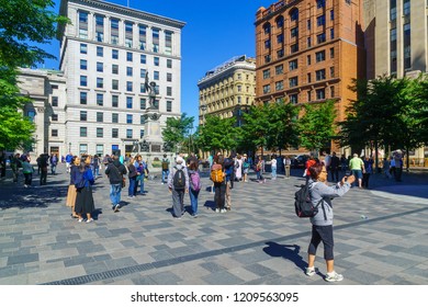 Montreal, Canada - September 08, 2018: Scene of Place dArmes square, with locals and visitors, in Montreal, Quebec, Canada