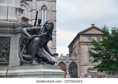 MONTREAL, CANADA - SEPTEMBER 3, 2018: Iroquois detail at the base of the statue of Paul Chomedey de Maisonneuve, founder of old Montreal, at Place d'Armes in Montreal.