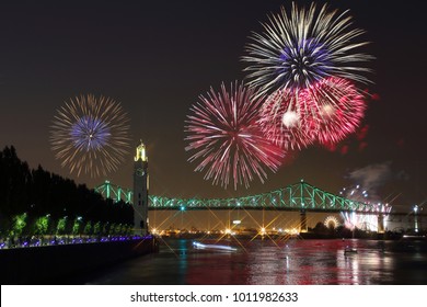 Montreal Clock Tower at night. Colorful fireworks explode over bridge, reflection in water. Montreal’s 375th anniversary. luminous colorful interactive Jacques Cartier Bridge. Old Port of Montreal. - Powered by Shutterstock