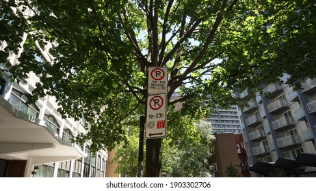 Montreal, QC- Canada - 6-24-2020: Parking challenge in downtown. No Parking signs: top (Wednesdays from 7:00 to 8:00 AM, from Apr 1st to Dec 1st), bottom (9:00 AM to 11:00 PM except for sector 13)