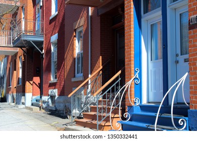 Montreal, QC / Canada - March 25 2019: Colorful Houses In The Street Of Plateau Mont Royal, A Trendy City Center Neighborhood Preferred By Students And Europeans And Heavily Gentrified.