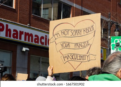 Montreal, QC/Canada - March 8, 2020: Woman Holding A Sign 