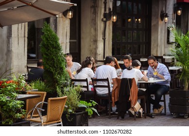 Montreal, Quebec /Canada - 07-17-2018: Group Of Young Adults Dining Outside At Sidewalk Cafe In Summertime