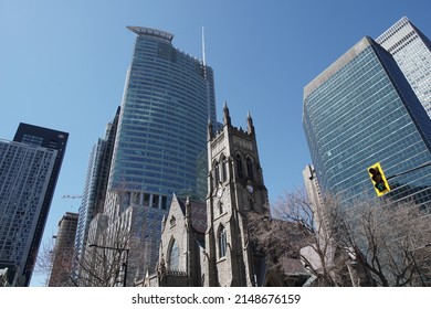 Montreal, Quebec, Canada - April 12, 2022: View Of 1250 Boulevard René Lévesque And Other Skyscrapers Surrounding Saint George's Anglican Church