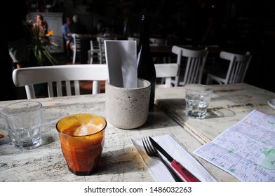 Montreal, Quebec / Canada - August 13, 2019: Planning A Day Of Travel Adventures In Old Montreal, Quebec In A Cafe With An Early Morning Latte While Studying A Map Of The City And Awaiting Breakfast.