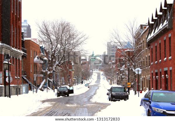 Montreal, Quebec / Canada - February 13 2019: a\
snowstorm covered the city. The roads are slippery and dangerous.\
Saint Andre street between Ville Marie and Plateau Mont Royal is\
all white and empty.