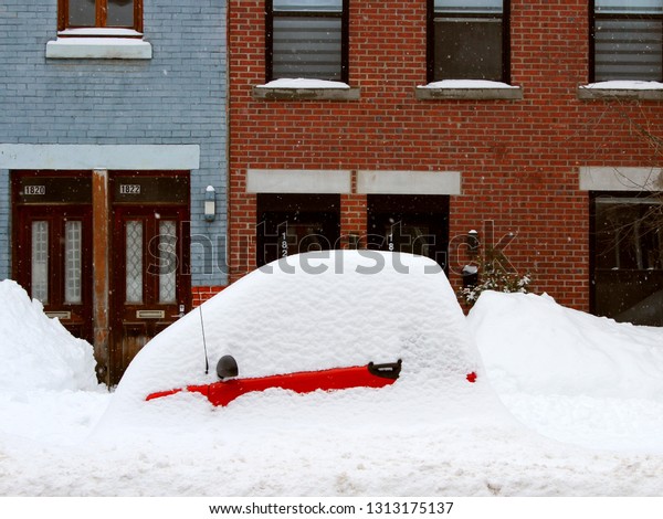 Montreal, Quebec / Canada - February 13 2019: the\
biggest snow storm of the winter covered the cars including this\
red Smart that is almost invisible under the mountain of snow on\
Plateau Mont Royal