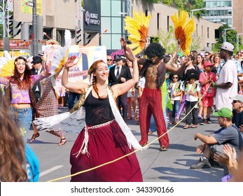 Montreal, Quebec, Canada - July 19 2014 - Parade Of The Twins . Identical Siblings March Together With Dancers To Flower Power Retro Hippy Music Of Hair  During The Just For Laughs Festival