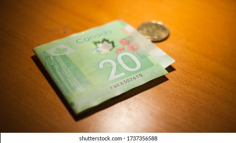 Montreal, Quebec / Canada - May 15 2020: Canadian Twenty Dollar Bill on Wooden Table