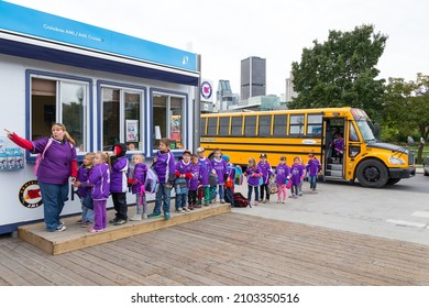 Montreal, Quebec, Canada, September 25, 2015 - Small school children in purple uniform lined up with their teacher to wait for a cruise on the St. Lawrence River