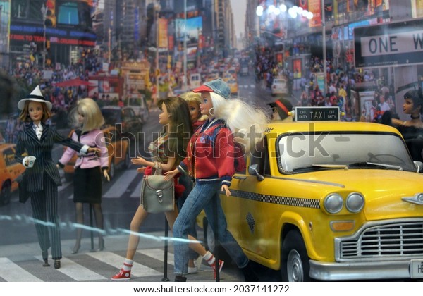Montreal, Quebec - July 19 2019: beautiful\
dolls in children and adults\' museum Barbie Expo that shows fashion\
history in toys. New York city Times Square diorama with yellow\
taxi car and\
pedestrians.