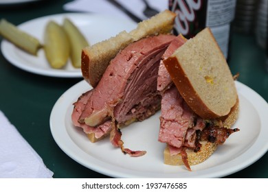 
Montreal Smoked Meat Sandwich With Pickles And Soda In Background