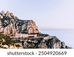 Montserrat mountain range and monastery landscape bathed in a sea of pastel clouds