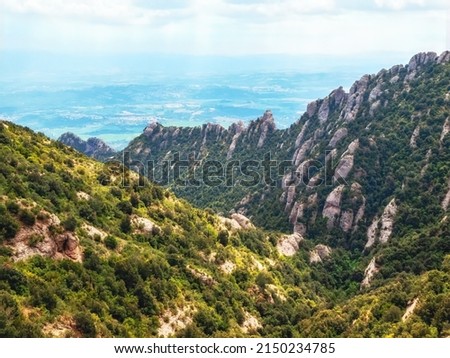 Montserrat is a multi-peaked mountain located near the city of Barcelona, in Catalonia, Spain. It is part of the Catalan Pre-Coastal Range.