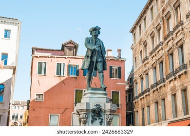 Monument of Carlo Goldoni at square with old buildings in Venice, Italy