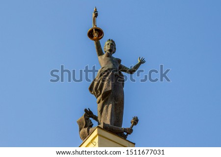 A monument to feminism. Old Vilnius Power Plant. Lamp in Hand. Beautiful Woman Statue Images.
