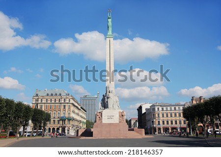 Monument of freedom in Riga. Woman holding three gold stars which symbolise three regions of Latvia.