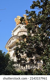 Monument On Stone Plinth With Golden  Chariot In Trees