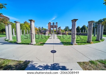 Monument of stone pillars leading to old ruins in park