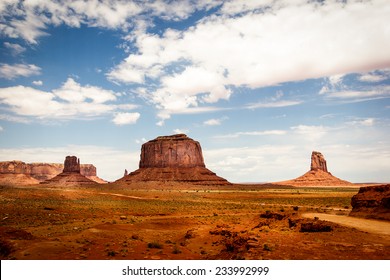 Monument Valley Navajo Tribal Park, Mittens And Clouds In The Blue Sky. American Landscape, Natural Wonder