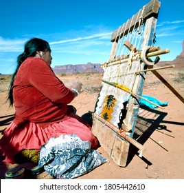 MONUMENT VALLEY, U.S.A.-SEPTEMBER 19,2001: Navajo Indian Woman Weaving Rug at Monument Valley, Utah, U.S.A.