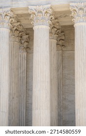 Monumental columns define classical architecture. Tall marble pillars shape historic architecture. White stone columns express civic architecture. Supreme Court columns suggest justice and authority.