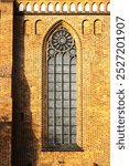 Monumental gothic cathedral window on brick wall