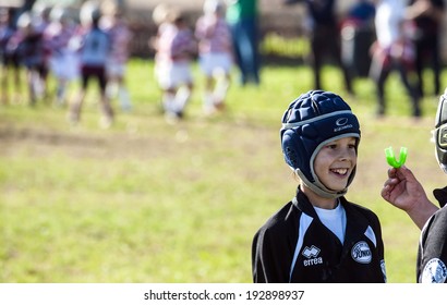MONZA, ITALY-OCTOBER 25, 2009: young rugby player under 8 of the Amatori Milano Rugby team, showing a safety protection for teeth, during a mini rugby tournament, in Monza.