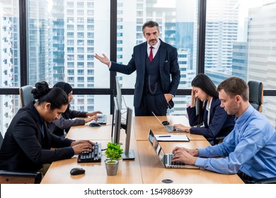 Moody Or Angry Boss Complaining Team About Mistake In Workplace Concept. Businessman Managers Pointing Out Mistake To His Team. Toxic Work Environment Concept