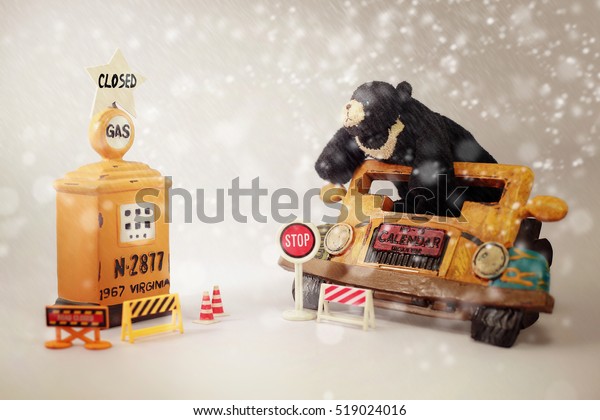 Moody\
bear on classic vehicle against snow landscape\
.