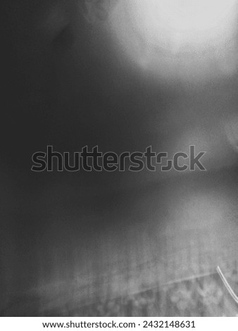 Moody black and white abstract with swirling smoke - Vertical shot with blurry background, giving off an anxious vibe.