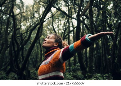Moody color concept of people and love for nature and planet earth. One person with arms up hugging forest trees around and smiling happy. Environment and woman tourist concept lifestyle - Shutterstock ID 2177555507
