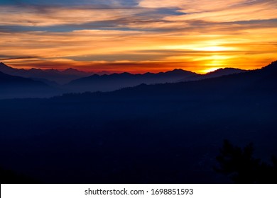 Moody, distant sunset -- Himalayas, India