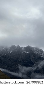 Moody highland scene with dramatic clouds and rugged rocky terrain.