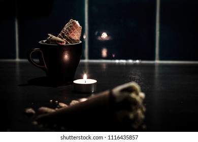 Moody Ice Cream By Candlelight On Dark Kitchen Bench