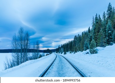 Moody lenticular clouds over the BNSF tracks adjacent to Long Lake in Lassen County, California USA.  Image was shot at dawn on a winter morning.