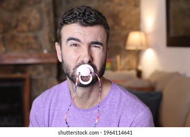 Moody man using a pacifier