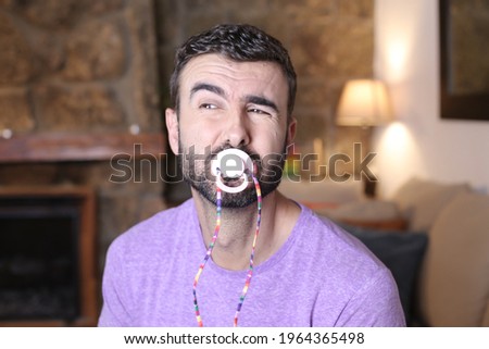 Moody man using a pacifier