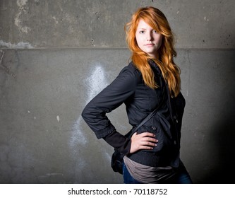 Moody Portrait Of A Beautiful Fashionable Young Redhead Girl.