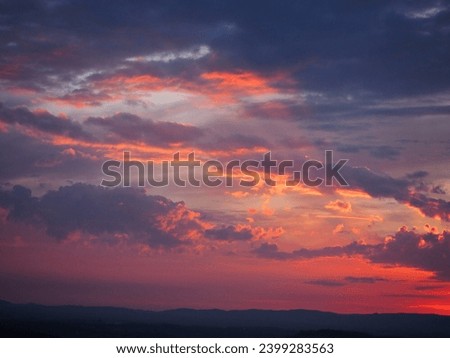 moody red sky in the evening over the Tuscan landscape 